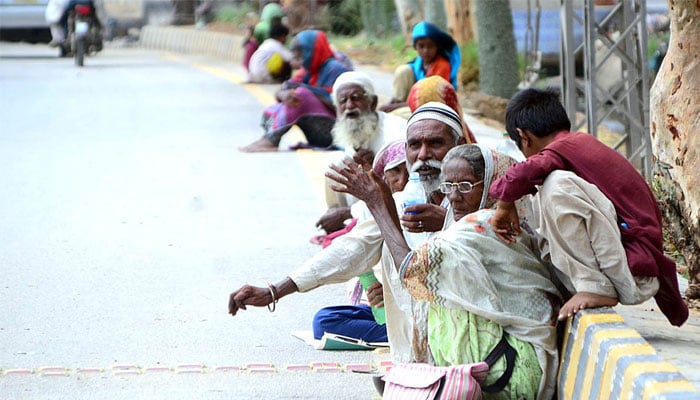 The representational image shows a group of beggars sitting roadside in Qasimabad on July 17, 2021. — APP