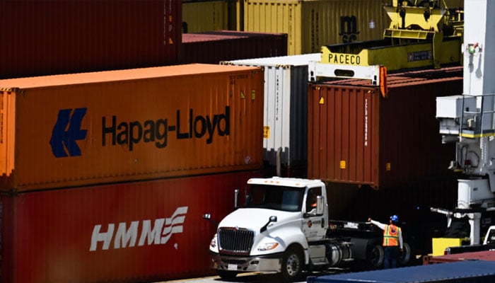 A goods transport truck is seen with containers in the background. — AFP/file