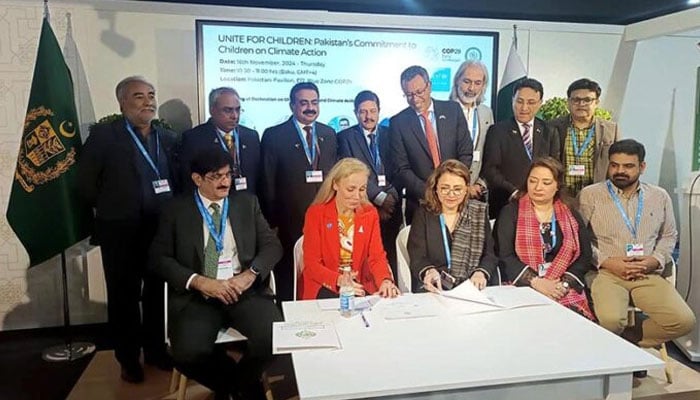 Secretary Climate Change & Environmental Coordination Ministry Aisha Humera Moriani (third from left in front row) and UNICEFs Deputy Executive Director Kitty Van der Heijden (second from left in front row) sign the Declaration on Children, Youth and Climate Action, a pledge by champion governments to uphold priorities identified by children and youth across the world at the Pakistan Pavilion at COP29. — APP/file