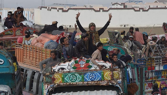 Afghan refugees arrive on trucks to cross the Pakistan-Afghanistan Chaman border on November 4, 2023. — AFP