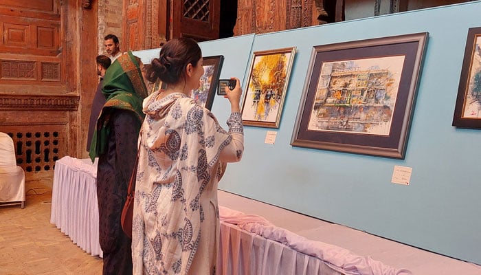 Women taking pictures of paintings at an exhibition  at the Sethi House on November 16, 2024. — Facebook@Shahidalikhanlala