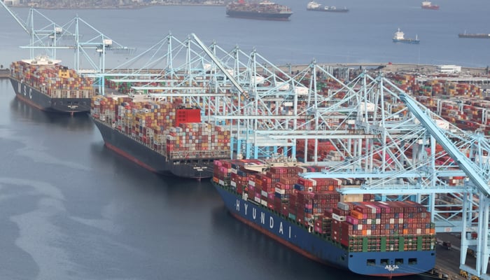 Shipping containers are unloaded from ships at a container terminal at the Port of Long Beach-Port of Los Angeles complex in Los Angeles, California, US, April 7, 2021. — Reuters