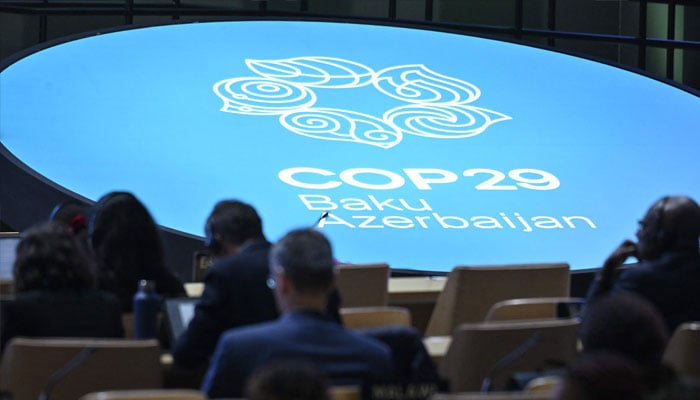 Participants listen to speeches during the United Nations Climate Change Conference (COP29) in Baku on November 13, 2024. — AFP