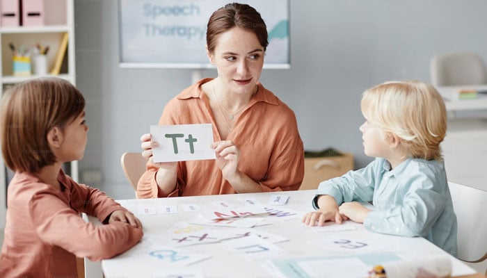 The representational image shows a teacher giving early language lessons to young students. — Unsplash/File