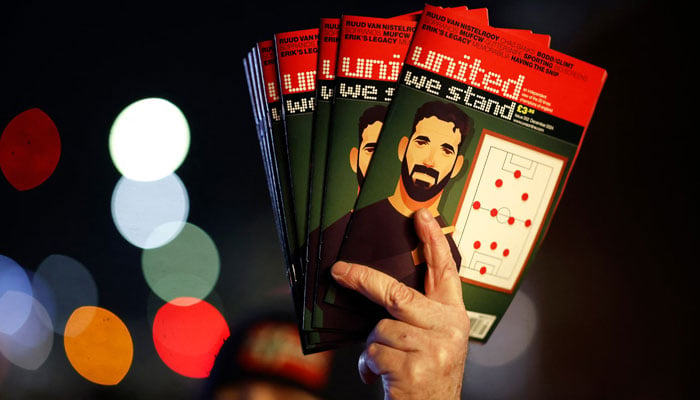 An image of new Manchester United manager Ruben Amorim is seen on the cover of a fan magazine outside the stadium before the match. — Reuters/File