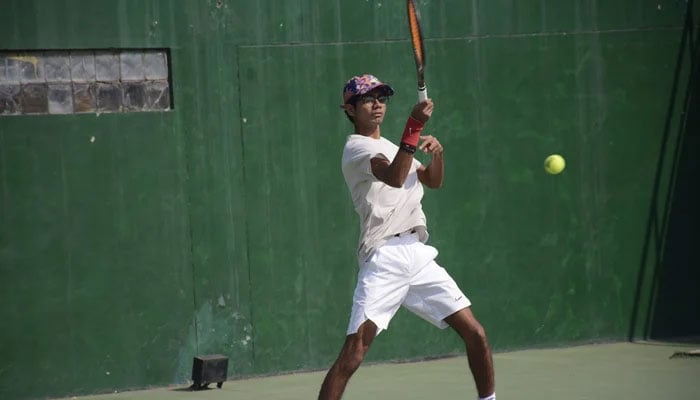 Ahmed Nael Qureshi while taking a shot in this image released on February 22, 2024. — Facebook/Pakistan Tennis Federation