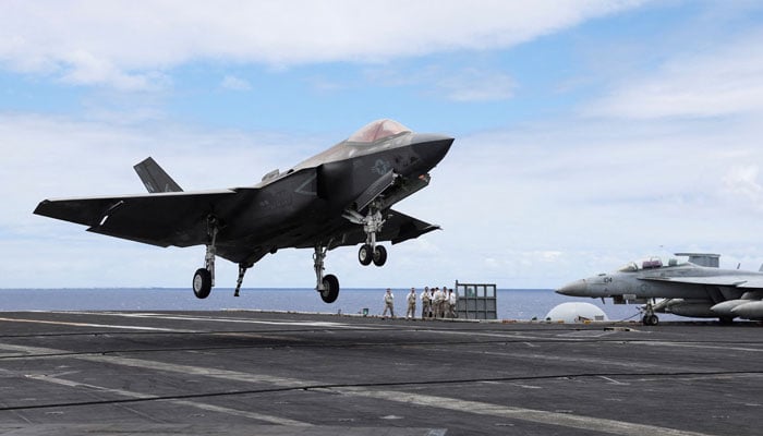 An F-35 jet lands on the runway of the USS Carl Vinson aircraft carrier during the Rim of the Pacific (RIMPAC) military exercises about 100 miles south of Oahu, Hawaii, US on July 19, 2024.— Reuters