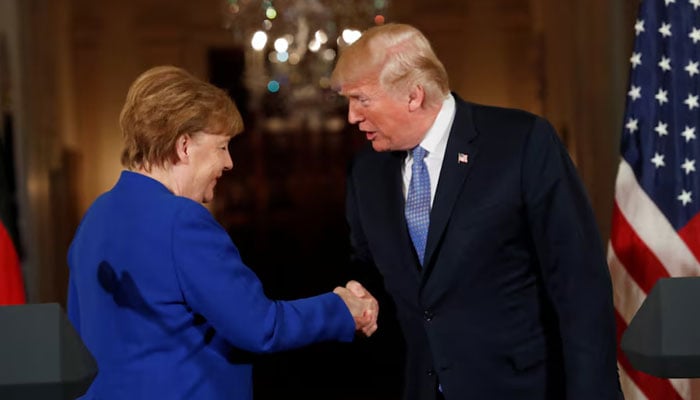 US President Donald Trump greets Germanys Chancellor Angela Merkel after a joint news conference in the East Room of the White House in Washington, US on April 27, 2018.—  Reuters