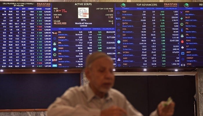 A stock broker watches share prices during a trading session at the PSX in Karachi on July 31, 2023. — AFP