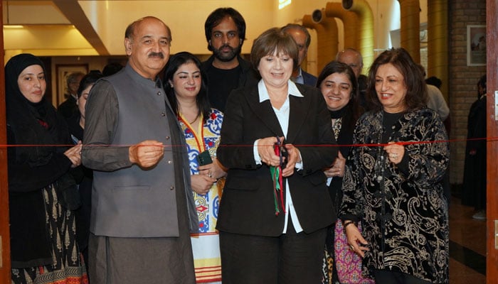 Deputy Chief of Mission at the Australian High Commission Nicole Guihot cuts a ribbon to inaugurate the exhibition at the National Art Gallery, Islamabad on November 22, 2024. — Facebook@PNCAOfficial