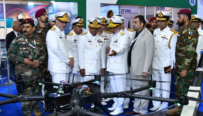 Chief of the Naval Staff Admiral Naveed Ashraf being briefed at a stall during the International Defence Exhibition and Seminar-2024 (IDEAS) on November 21, 2024. — Facebook@DgprNavy