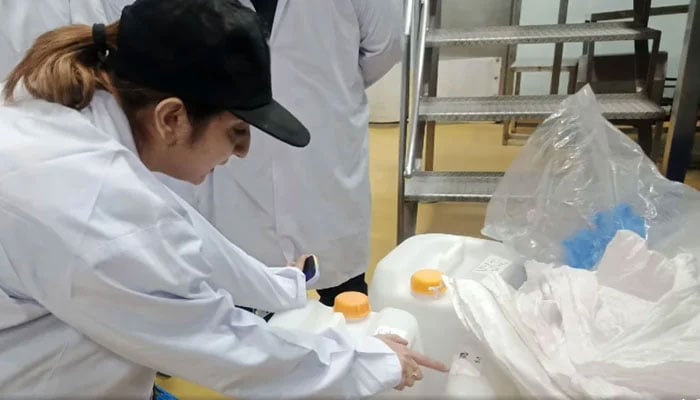 The representational image shows a Sindh Food Authority official inspecting a sauce and spread factory in Korangi, Karachi. — Facebook@SindhFood/File