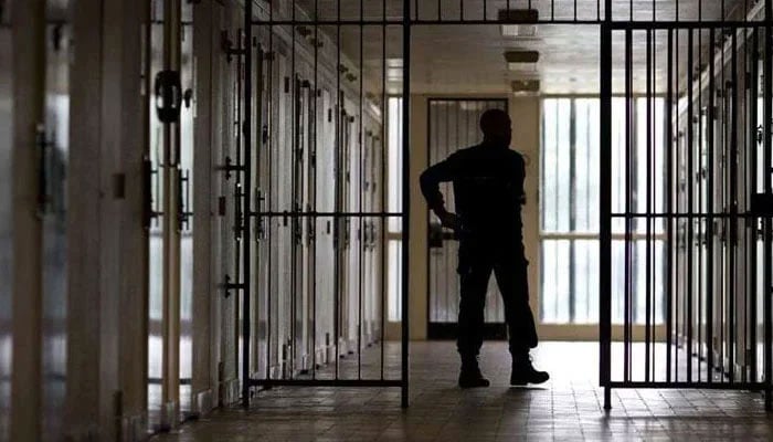 The representational image shows a security official standing guard in jail in this undated photo. — AFP/File