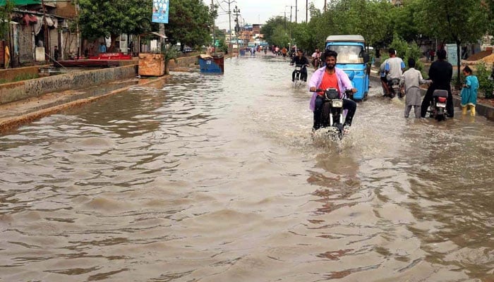 Commuters are facing difficulties in transportation due to stagnant rainwater causing of poor sewerage system after heavy downpour of monsoon season, at North Karachi area in Karachi on August 29, 2024. — PPI