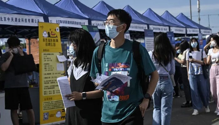 People attend a job fair in Beijing on Aug. 26, 2022. — AFP