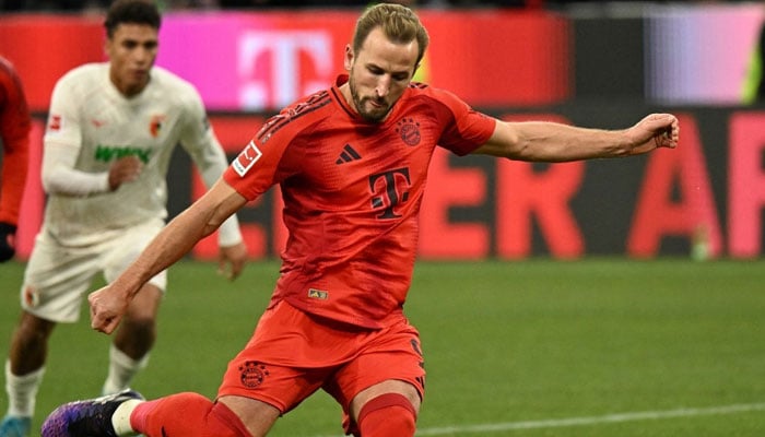 Bayern Munichs Harry Kane scoring the 2-0 goal from the penalty spot during the German first division Bundesliga football match FC Bayern Munich vs FC Augsburg in Munich, southern Germany, on November 22, 2024.— AFP