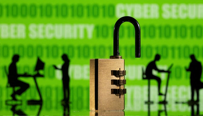 3D printed models of people working on computers and padlock are seen in front of a displayed CYBER SECURITY words and binary code in this picture illustration taken, February 1, 2022. — Reuters