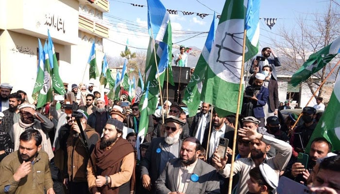 Jamaat-e-Islami (JI) supporters and workers hold party flags during an election rally on February 6, 2024. — Facebook@Siraj ul Haq