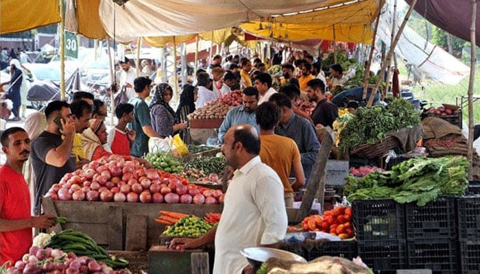 People buy vegetables and fruits at a weekly bazar located in the Shadman area of Lahore on September 22, 2024. — PPI