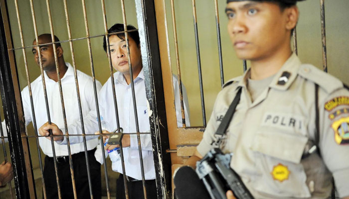 Australian prisoners Andrew Chan (centre) and Myuran Sukumaran (left), the ringleaders of the “Bali Nine” drug smuggling gang, wait to attend a review hearing in the District Court of Denpasar on Bali, in October 2010. They were executed in 2015 along with six other prisoners. — Reuters