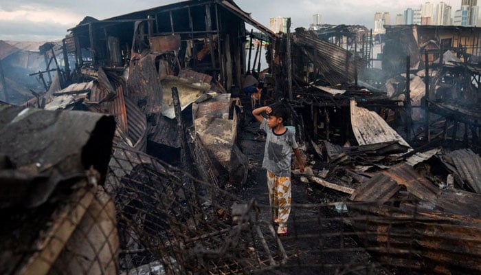 A child stands amid the wreckage of a destroyed house. — Reuters/File