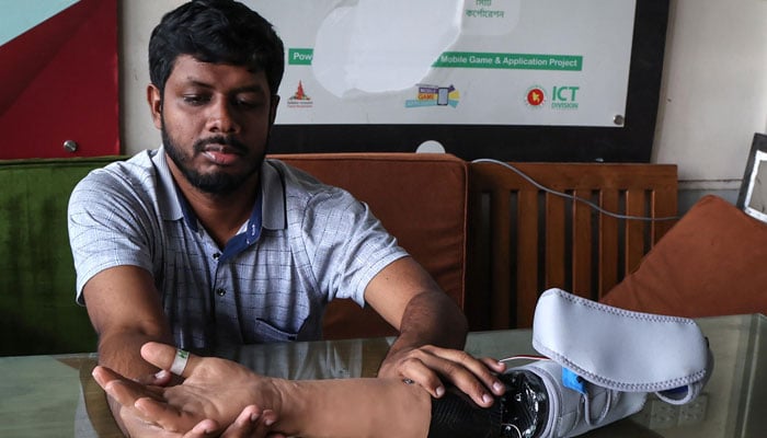 A man examining a robotic arm. — AFP/file