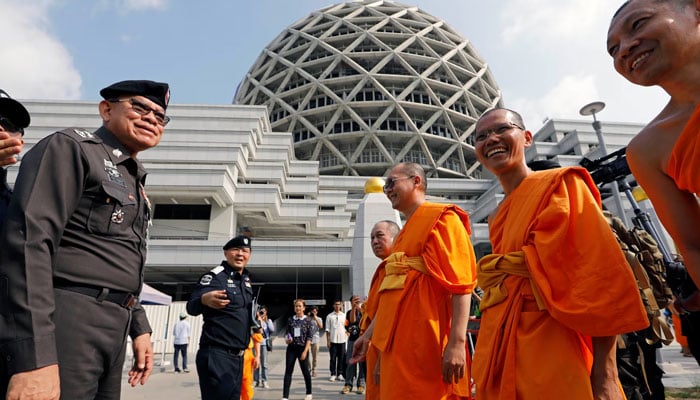 Officers from Thailand’s department of special investigation are met by monks as they arrive to inspect the Dhammakaya complex.— Reuters/file