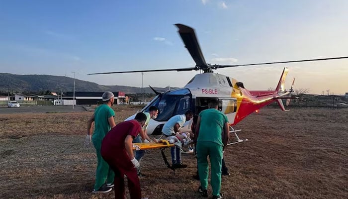 An injured victim is carried to a helicopter after being rescued from a bus that crashed in the northeastern state of Alagoas, Brazil on November 25, 2024. — Reuters