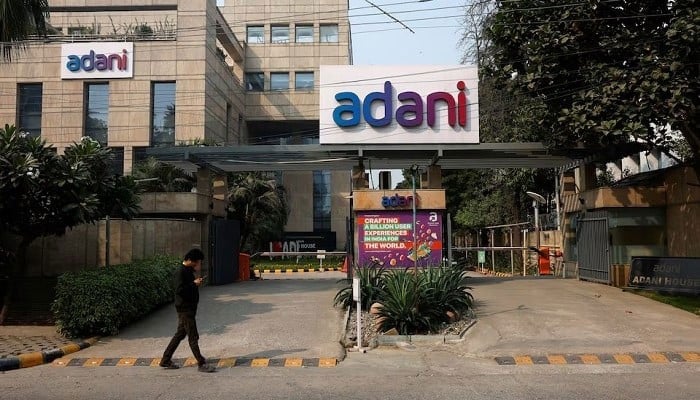 A man walks past a corporate office of Adani Group in Gurugram, India, November 22, 2024. — Reuters