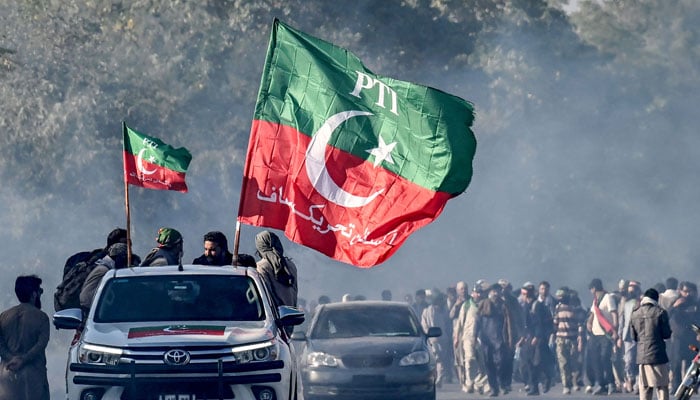 Supporters of jailed former prime minister Imran Khans PTI party march towards Islamabad after clearing shipping containers placed by authorities during a demonstration demanding Khans release on November 25, 2024. — AFP