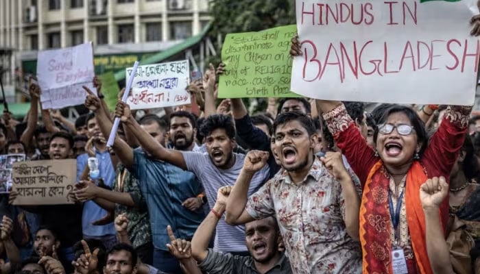 Members of the Bangladeshi Hindu community hold banners and chant slogans against violence targeting the countrys minorities during a protest in Dhaka on Aug 9, 2024. — AFP