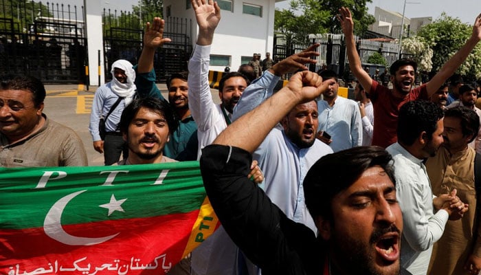 Supporters of the Pakistan Tehreek-e-Insaf (PTI) political party, chant slogans in support of  Imran Khan. — Reuters/File