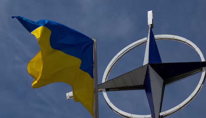 A Ukrainian national flag rises in front of the NATO emblem, amid Russias attack on Ukraine, in central Kyiv, Ukraine on July 11, 2023. — Reuters