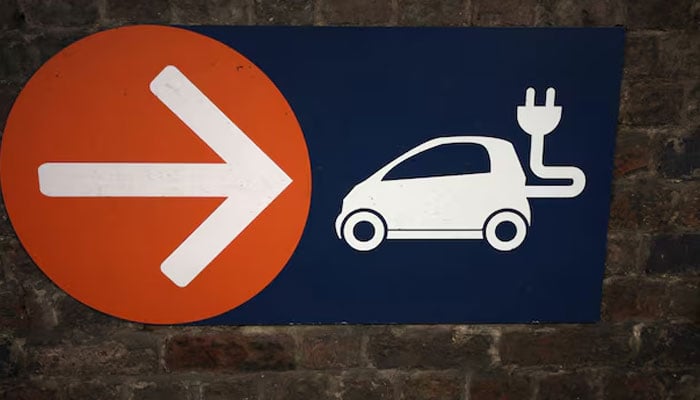 A sign directing towards electric vehicle charging points is seen in a car park in Manchester, Britain, September 8, 2023. — Reuters