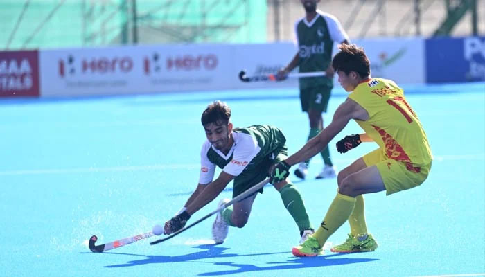 Pakistani hockey player (left) in action against China. —Facebook@asianhockeyfederation/File