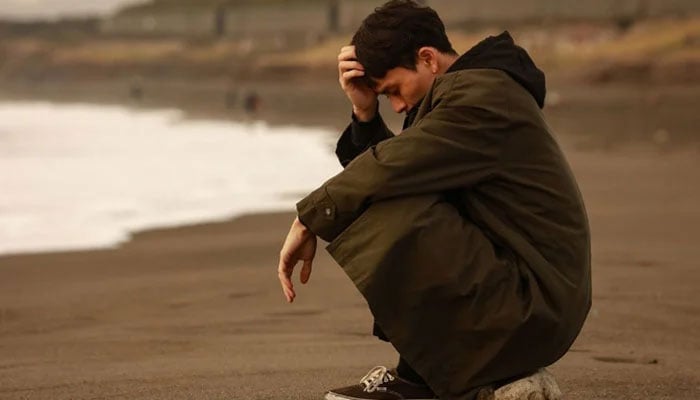 A representational image showing a person sitting at the beach. — Canva/File