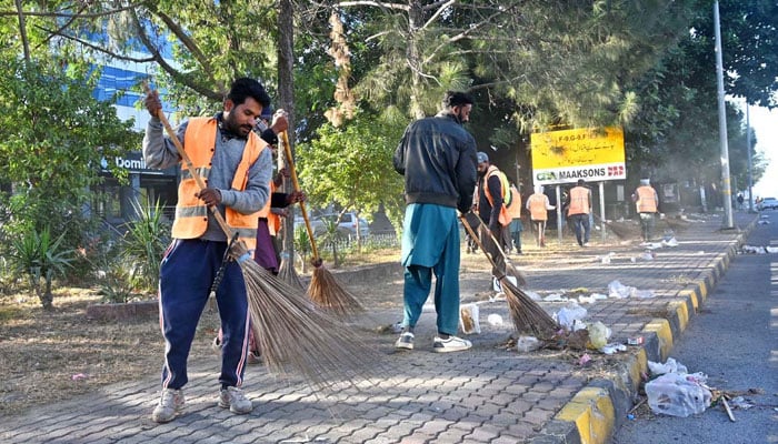 CDA workers are cleaning an area following the PTI protest in Islamabad on November 27, 2024. — APP