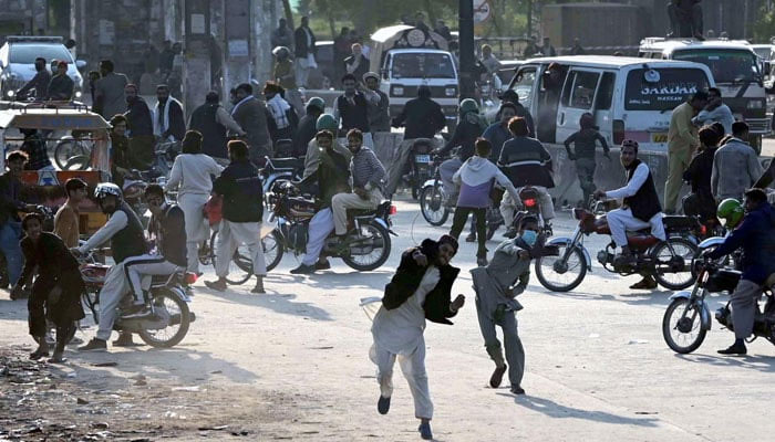 PTI workers throwing stone on police during the clash in Islamabad on November 24, 2024. — INP