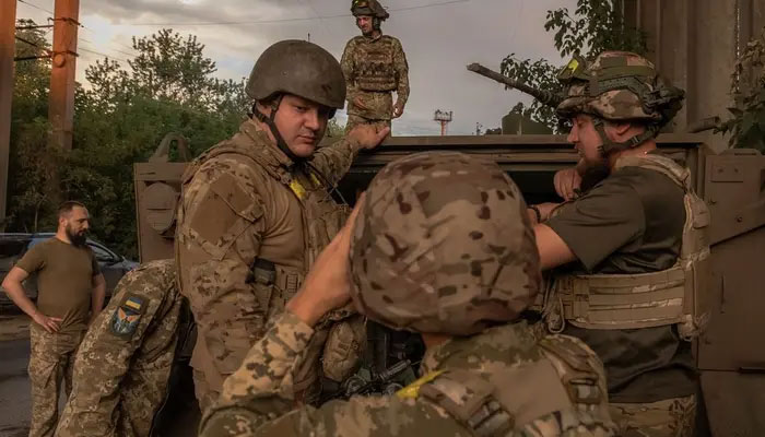 Ukrainian soldiers with their weapons board on a US-made M113 armoured personnel carrier to depart for the front in an undisclosed area, in the eastern Donetsk region, on August 5, 2024, amid the Russian invasion of Ukraine. —AFP