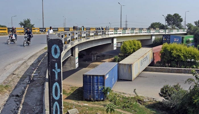 A view of Murree road blocked with shipping containers at Faizabad area during PTI protest at D-chowk in Islamabad on Oct 4, 2024. — ONLINE