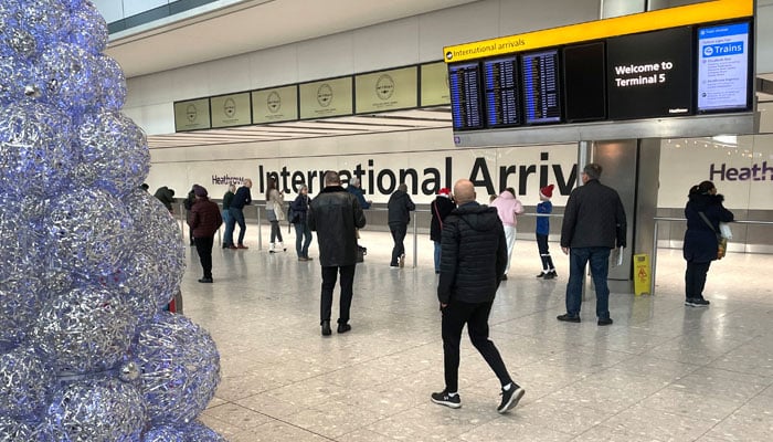 People wait in the arrivals hall at terminal 5 of Heathrow Airport, near London, Britain, December 23, 2022. — Reuters