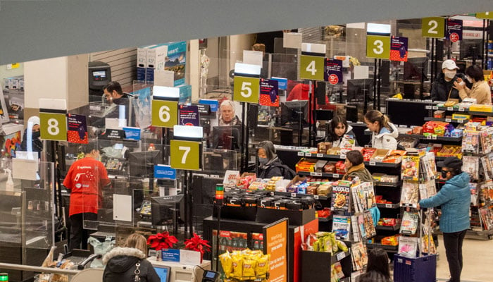 People pay for their items at a grocery store in Toronto, Ontario, Canada November 22, 2022. — Reuters