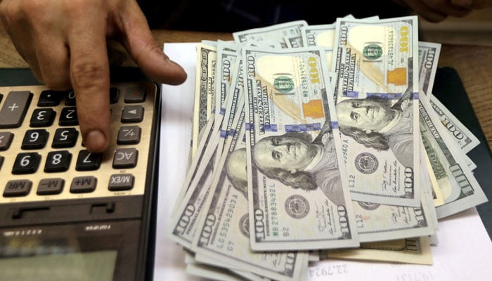 An employee counts US dollar bills at a money exchange in central Cairo, Egypt, March 20, 2019. — Reuters