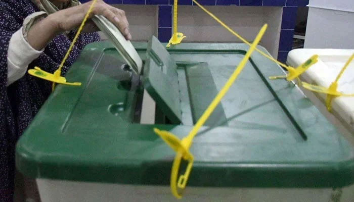 A woman puts her vote in the ballot box at a polling station on February 8, 2024. — Online