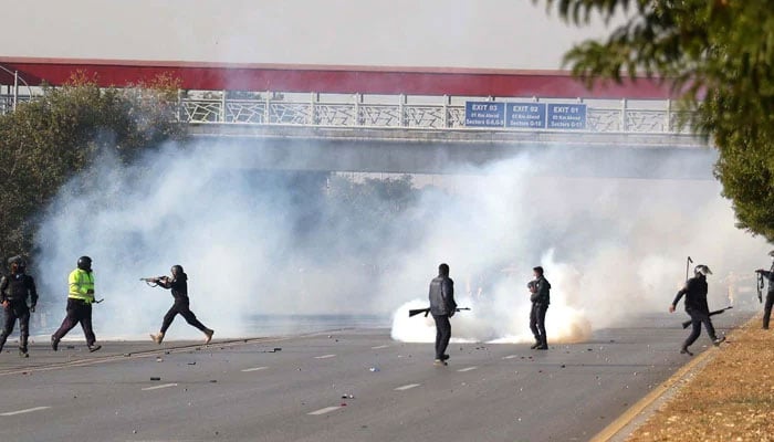 A view of the security personnel firing tear gas shell amidst clash with PTI protesters in Islamabad on November 26, 2024. — INP