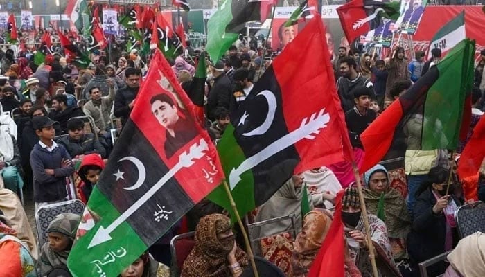 Pakistan Peoples Party (PPP) supporters wave flags in a rally on January 21, 2024. — AFP