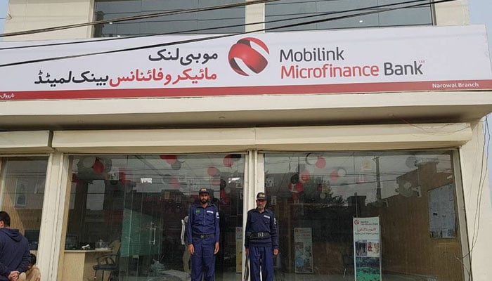 Security guards standing alert outside Mobilink Microfinance Bank Narowal branch. — Facebook@MobilinkMicrofinanceBankLimited/File