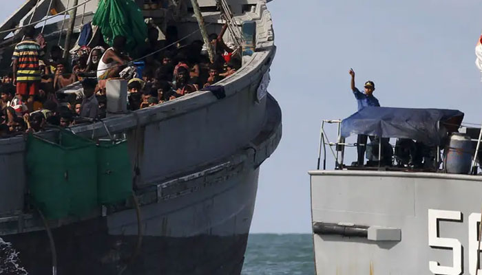 A boat carrying more than 700 migrants and refugees is being escorted to a safe location by Myanmars navy. — Reuters/File