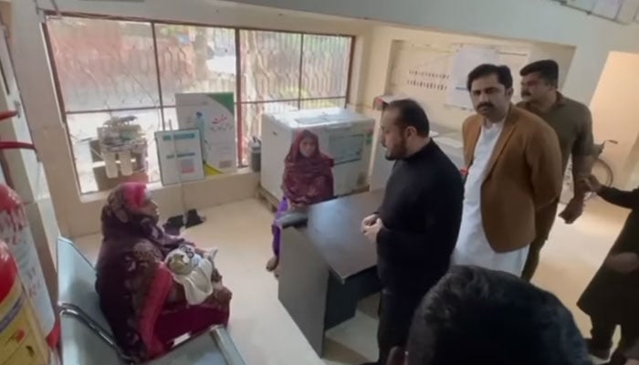 Punjab Minister for Primary and Secondary Healthcare Khawaja Imran Nazir (centre) speaks with a patient as he visits the Basic Health Unit (BHU) in Liddhar on December 1, 2024. — Screengrab via Facebook@KhawajaImranOfficial