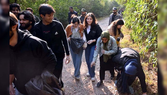 Students take part in the Margalla Hills Trail-5 cleanup drive during the 14th Pakistan Mountain Festival organised by Devcom-Pakistan on the eve of International Mountain Day, in Islamabad on December 1, 2024. — PPI